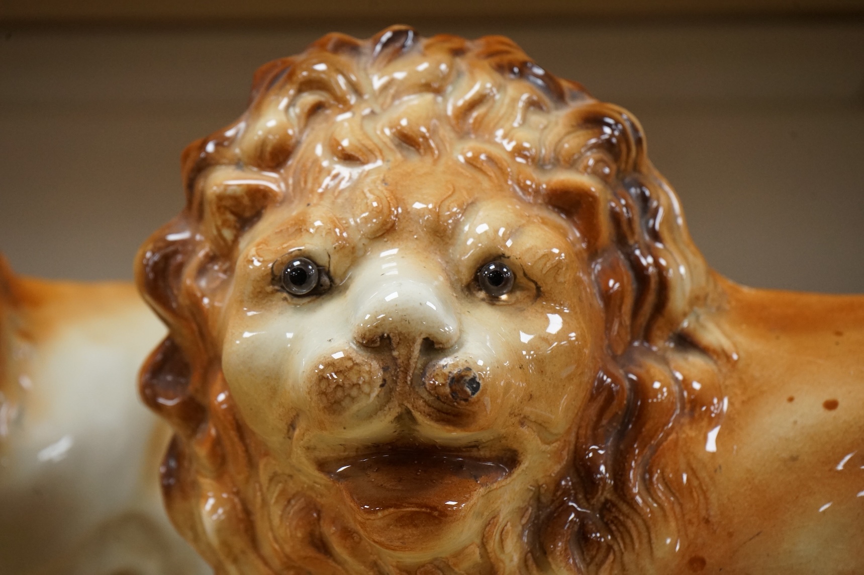A pair of Staffordshire pottery lions, c.1900, 34cm